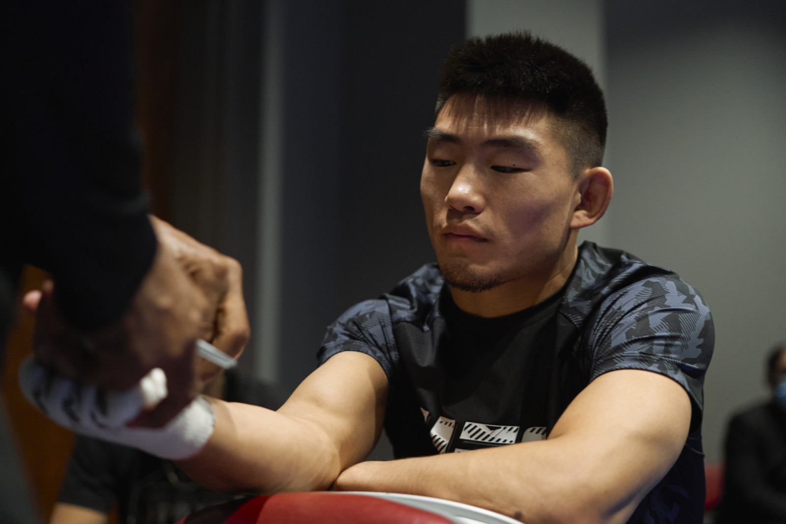 HOUSTON, TEXAS - AUGUST 07: Song Yadong of China gets his hands wrapped backstage during the UFC 265 event at Toyota Center on August 07, 2021 in Houston, Texas. (Photo by Cooper Neill/Zuffa LLC)