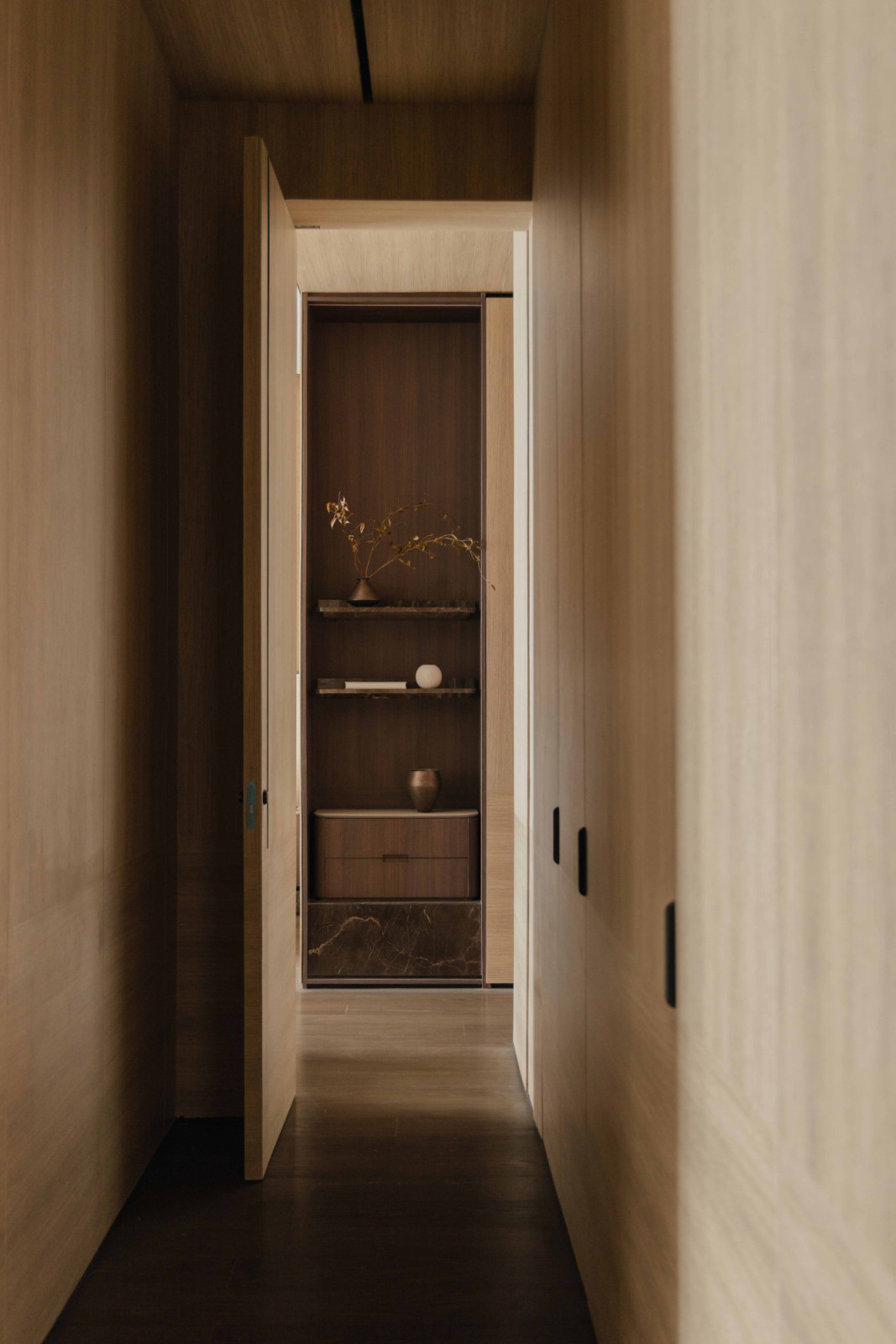 Timber-lined corridors frame carefully considered views through the private wing of the apartment