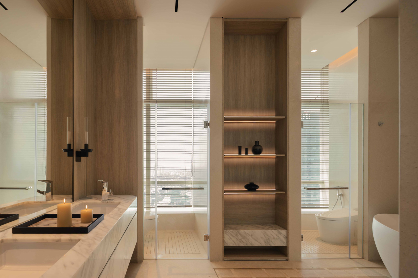 The enlarged master bathroom features twin sinks, open shelving and views across the Jakarta skyline