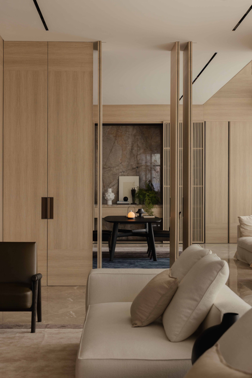 Large operable doors connect the living area to the study, extending sightlines across the common zone