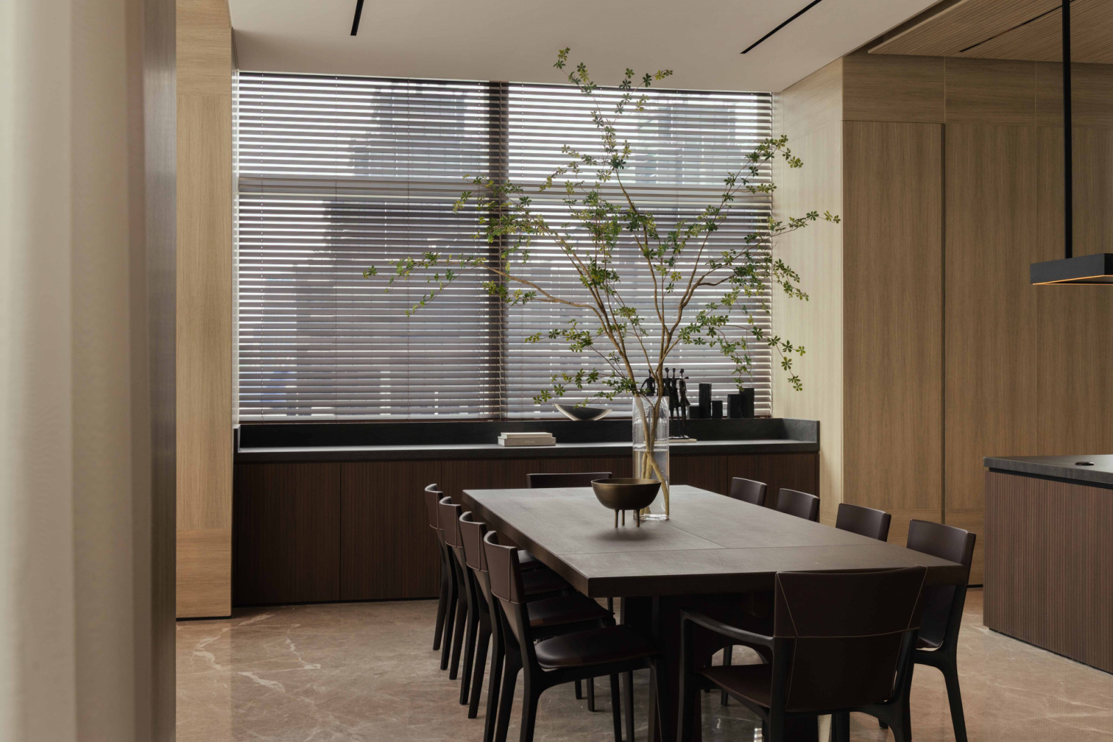The Poltrona Frau dining table seats the whole family against a backdrop of the Jakarta skyline.