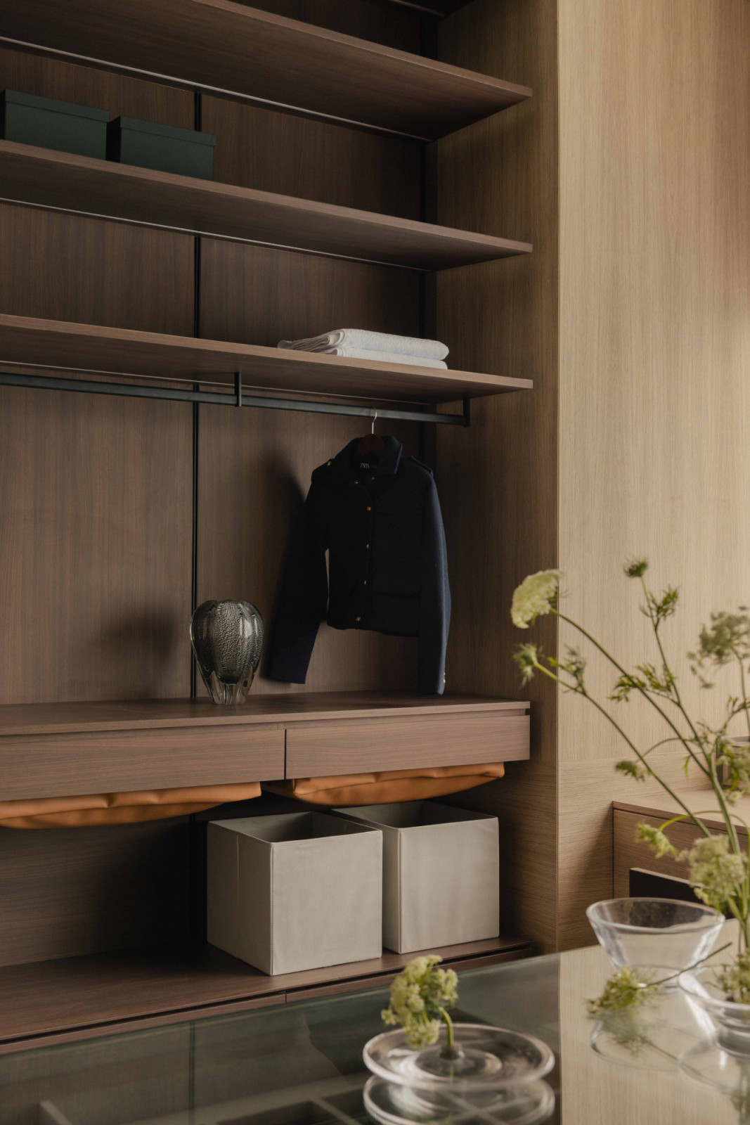 Open shelving in the walk-in wardrobe keeps the wife's wardrobe accessible and on display