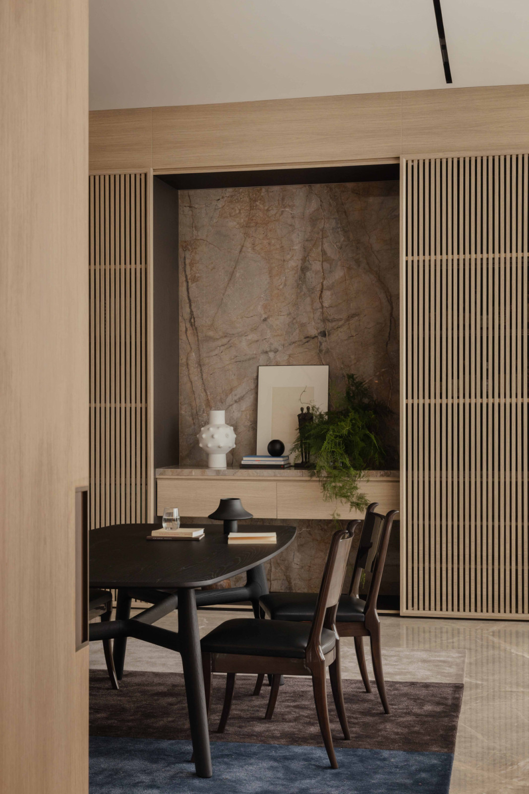 A stone-backed display niche in the study adds visual depth and a focal point for the room
