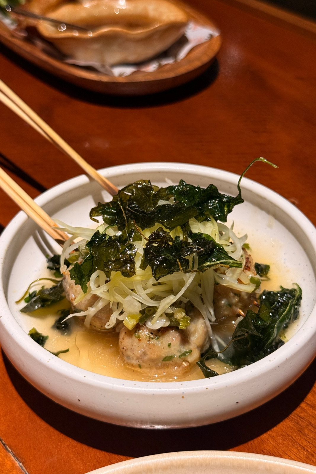 Chicken balls with pickled papaya, tinola sauce and chilli leaves from Toma Toma