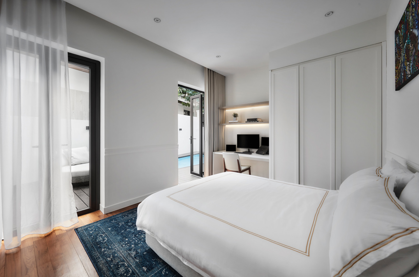 The guest room, with doors that conveniently open directly into the backyard and pool area
