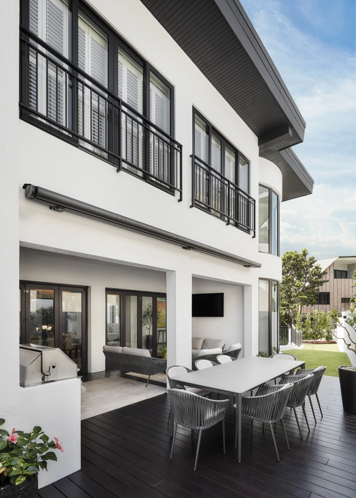 Outdoor dining and relaxed barbecues are made possible with the Quay ceramic dining table, Quay outdoor woven dining chairs, and a set of Quay outdoor sofas from King Living