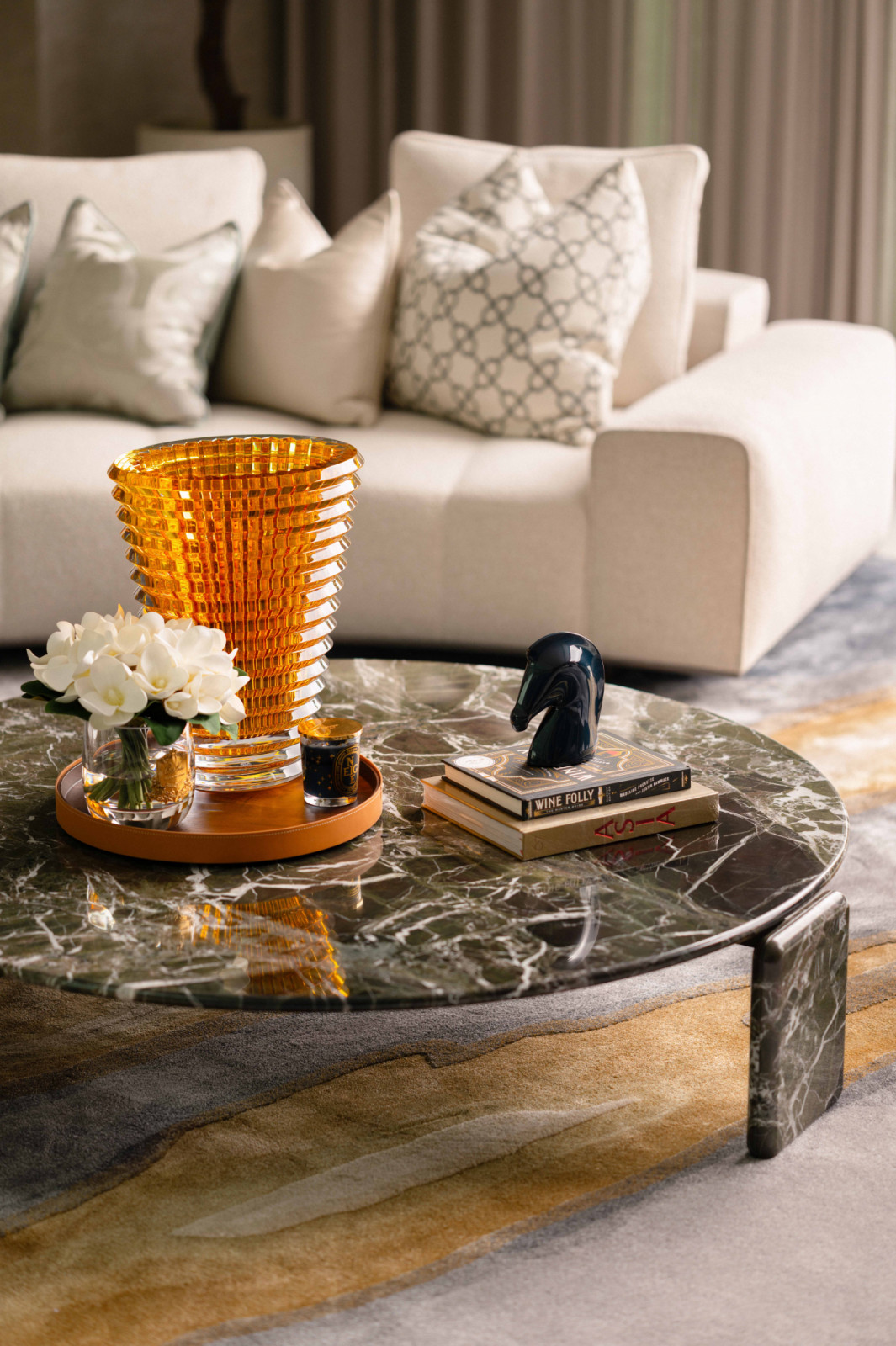 A Baccarat Eye crystal vase catches the light atop a Minotti Drake marble coffee table in the formal living room