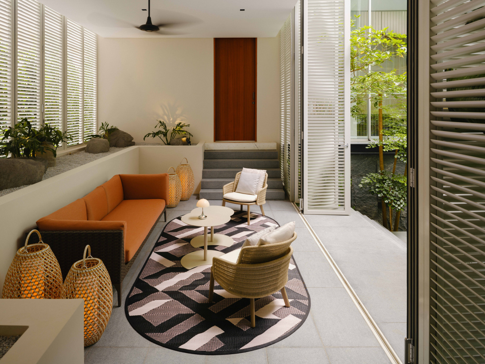 The mezzanine patio offers an intimate outdoor sitting area with Dedon furniture