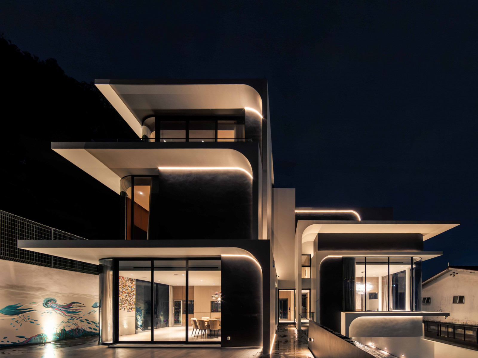 The facade of the house, aglow at night
