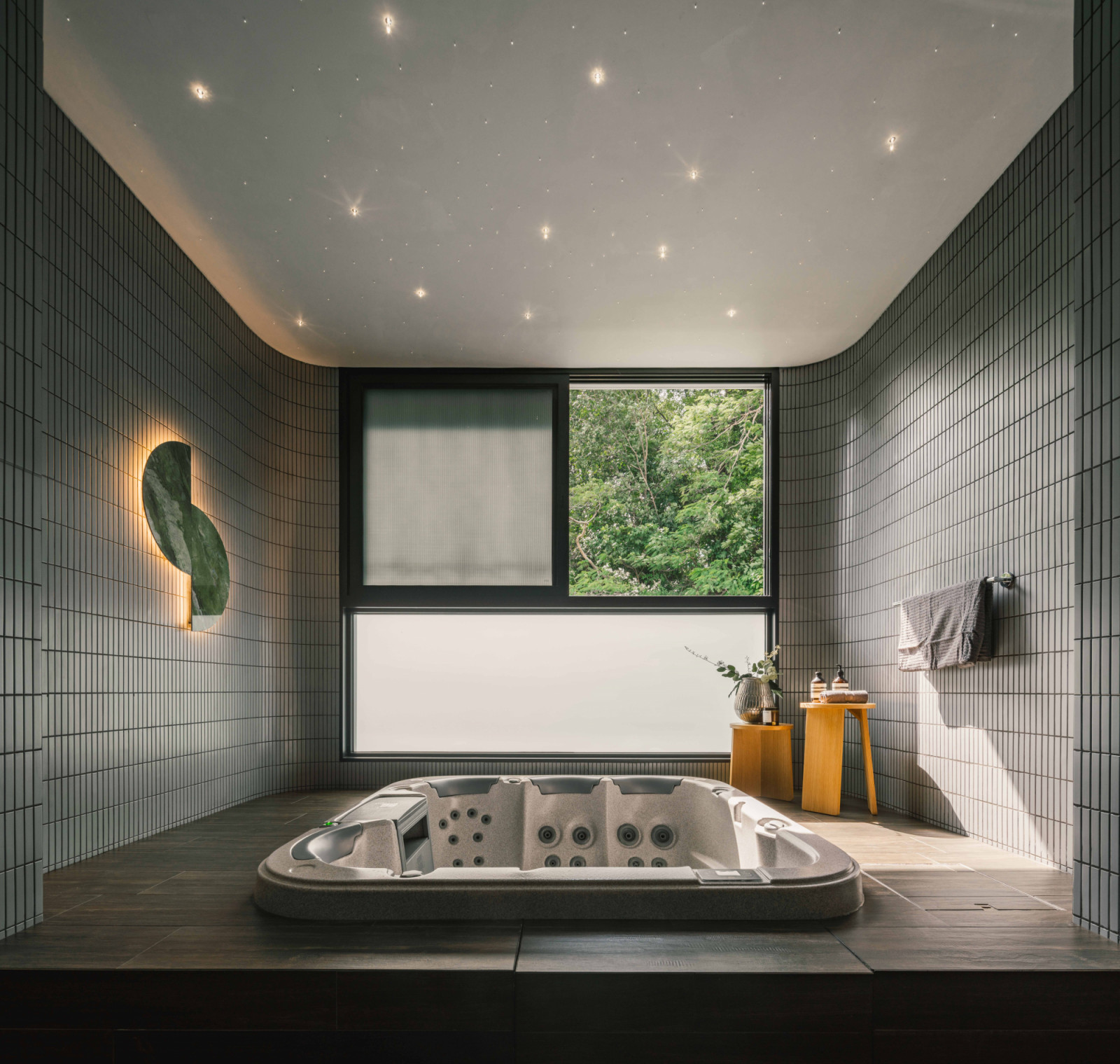 The jacuzzi looks out to serene vistas, with materials and textures carefully selected to convey a sense of tranquillity