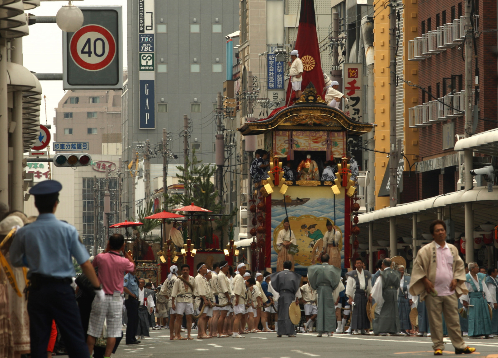 KYOTO, JAPAN - JULY 17:  People pull floats named Yamahoko during the annual Kyoto Gion Festival on July 17, 2013 in Kyoto, Japan. The Gion festival is one of three biggest Japanese festivals. dating back to the 9th century, the festival is part of a ritual intended to satisfy the Gods that brought on fire, floods and earthquakes. During the festival the streets are decorated with lanterns and many of the women dress in "yukata", summer kimonos.  (Photo by Buddhika Weerasinghe/Getty Images)