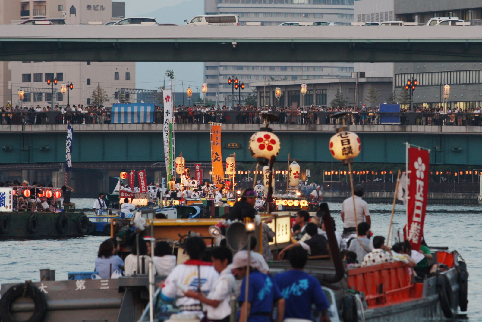 OSAKA, JAPAN - JULY 25:  People dressed in traditional costume ride decorated boats along the Okawa river during the annual Tenjin summer festival boat parade on July 25, 2013 in Osaka, Japan. The Tenjin Festival, one of the biggest festivals in Japan with over 1,000 years of history, is dedicated to Osakas prosperity and peoples peace. Hundreds of boats and ferries, decorated with lighted lanterns, join a procession at the end of the Tenjin summer festival each year.  (Photo by Buddhika Weerasinghe/Getty I