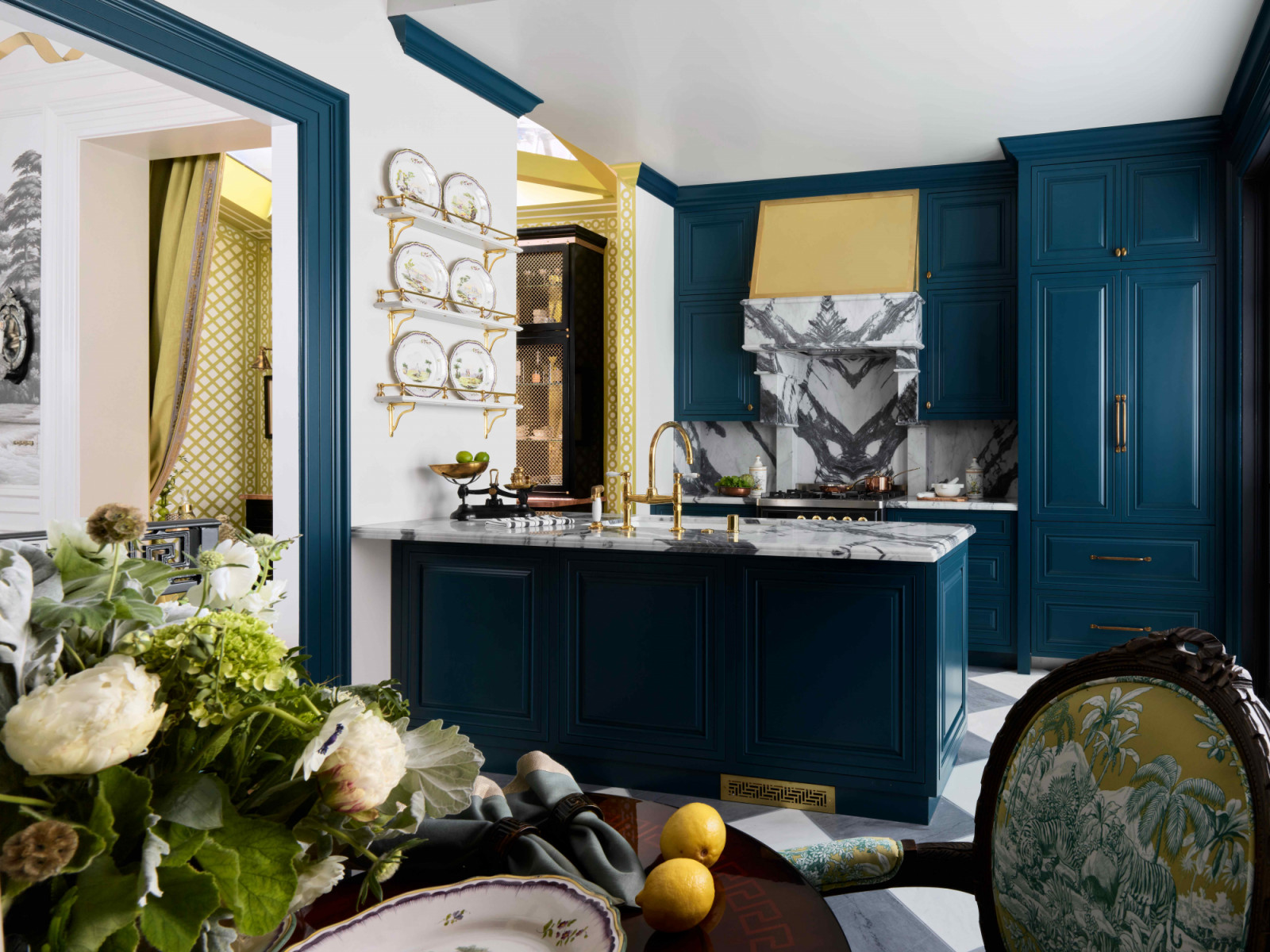 The kitchen houses a custom hood and bespoke cabinetry