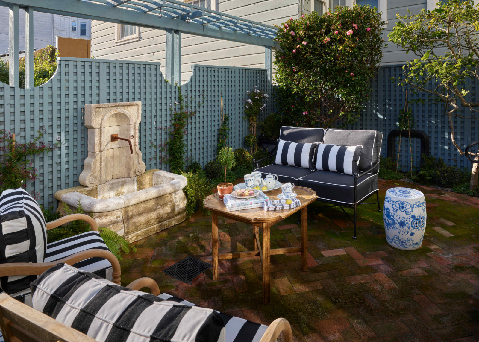 The kitchen opens directly onto the backyard with a garden