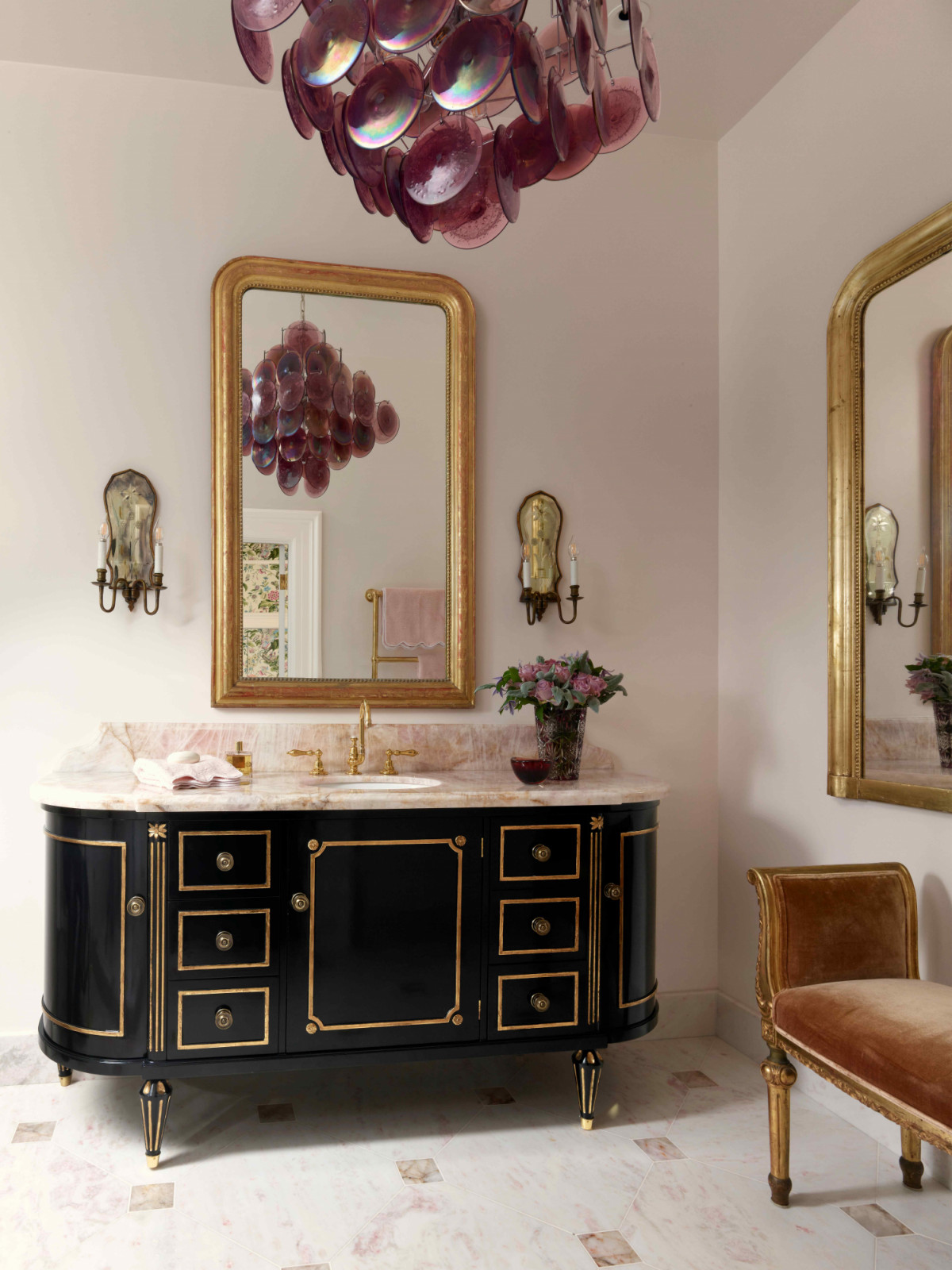 Positioned next to the parlour is the primary bathroom in tinges of blush pink