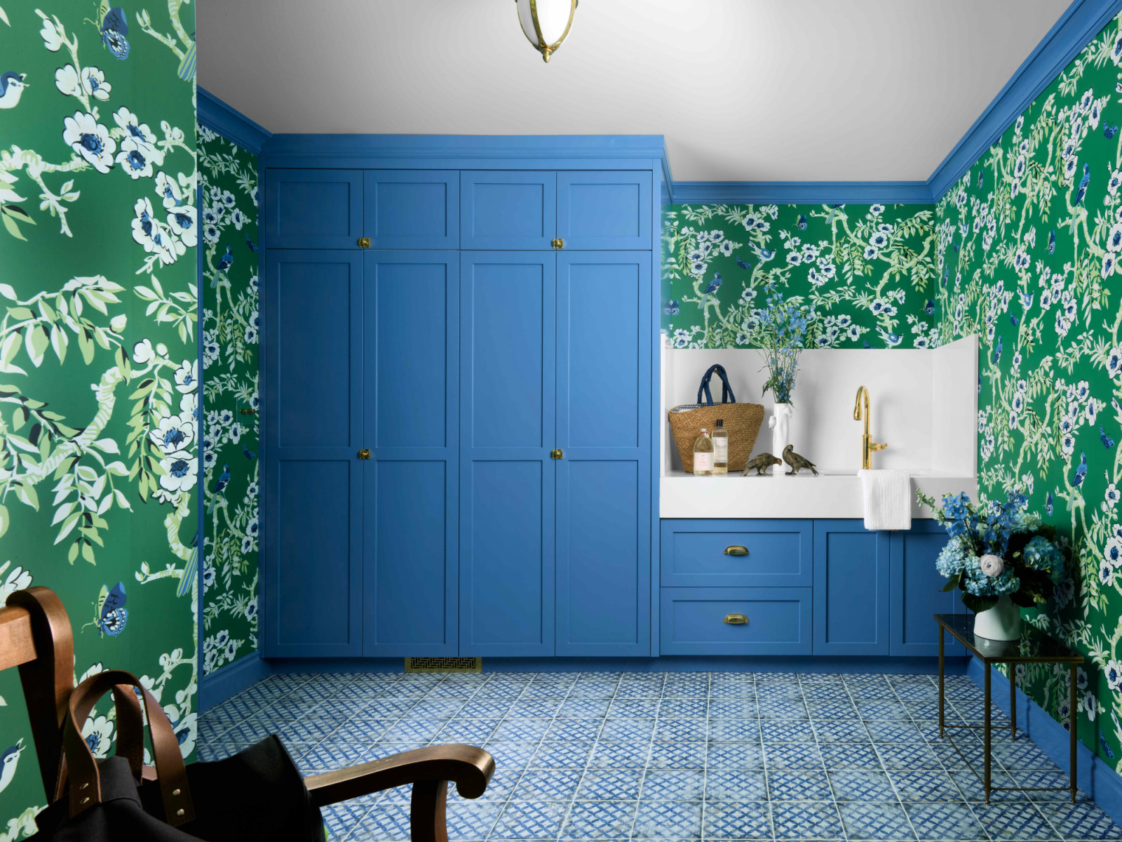 The mudroom and dog spa area, enveloped in cheerful Thibaut garden wallpaper