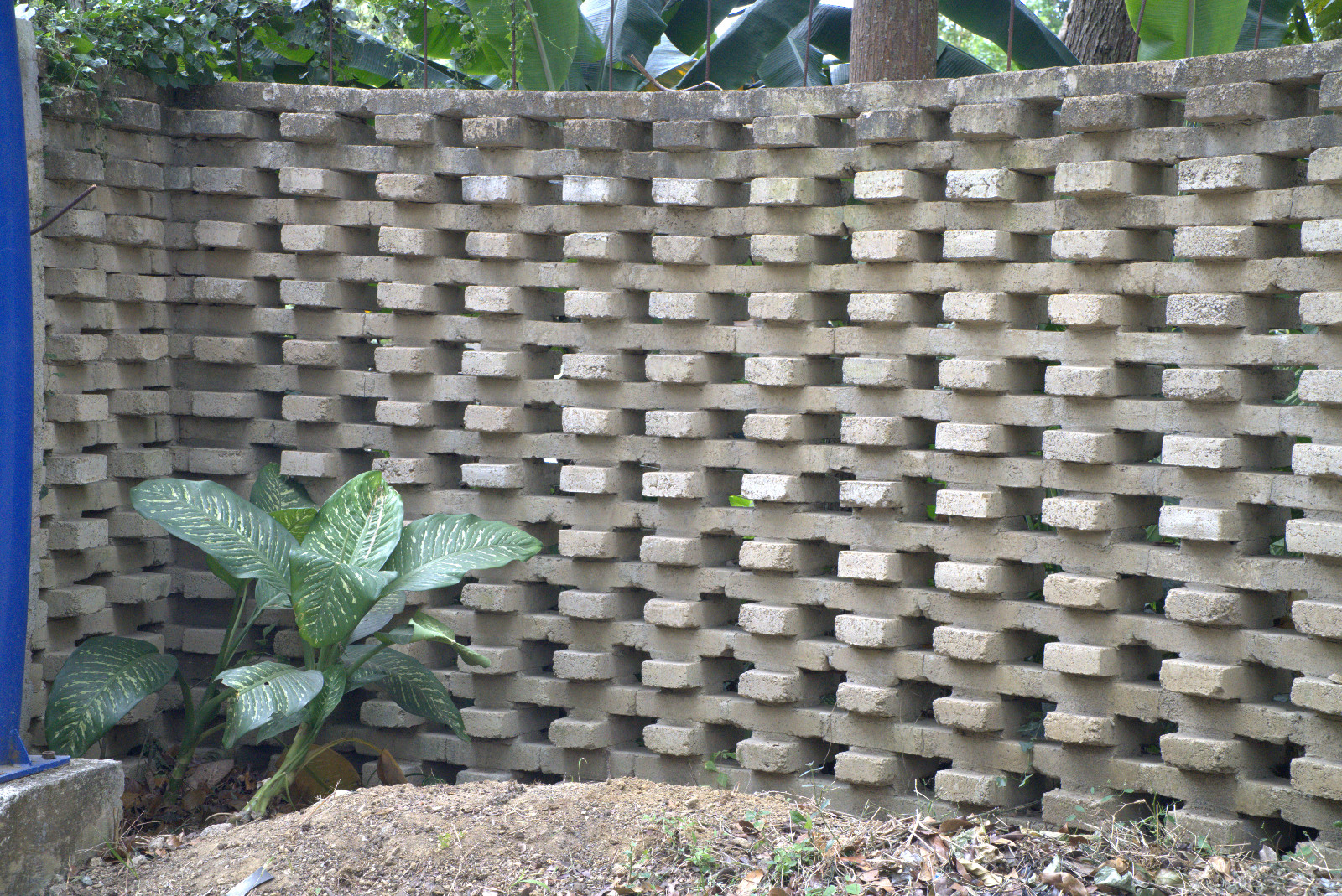 Rammed earth blocks are stacked to create a porous, decorative wall