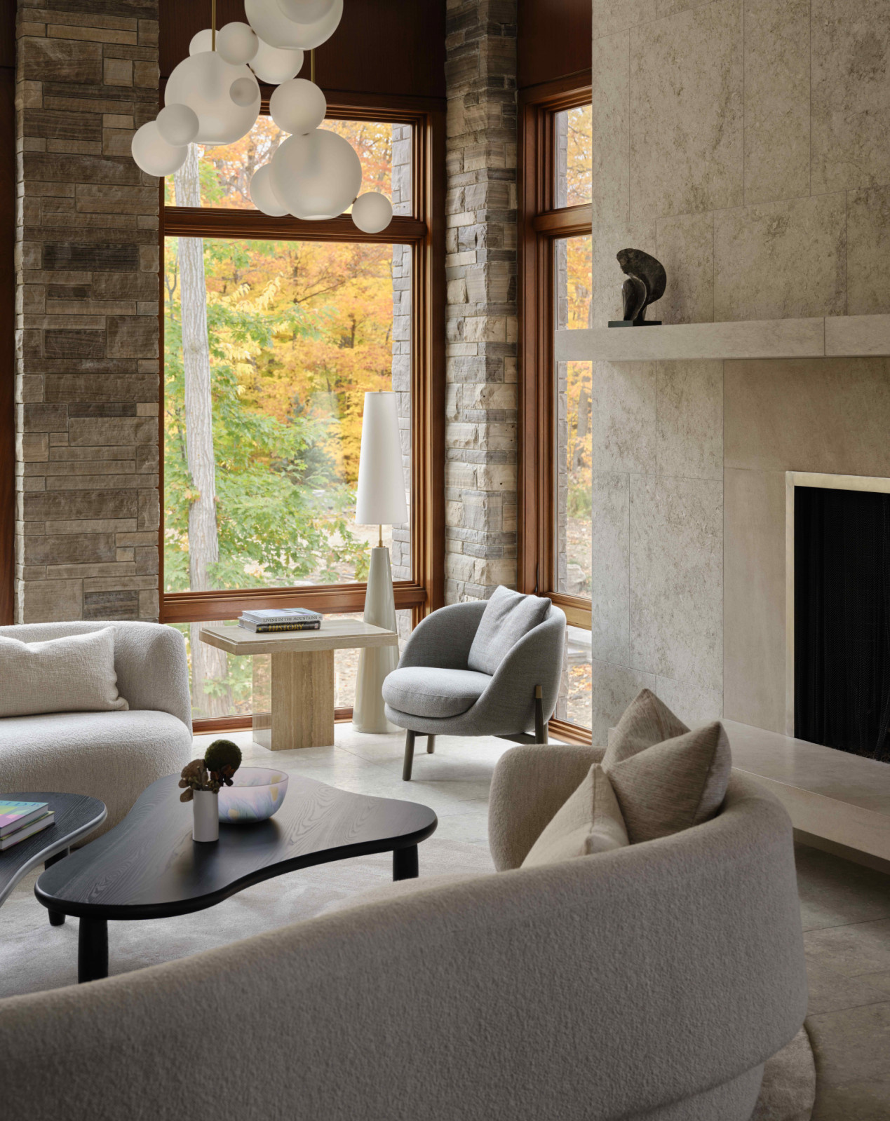 The existing rough-stone columns frame views of the surrounding forest