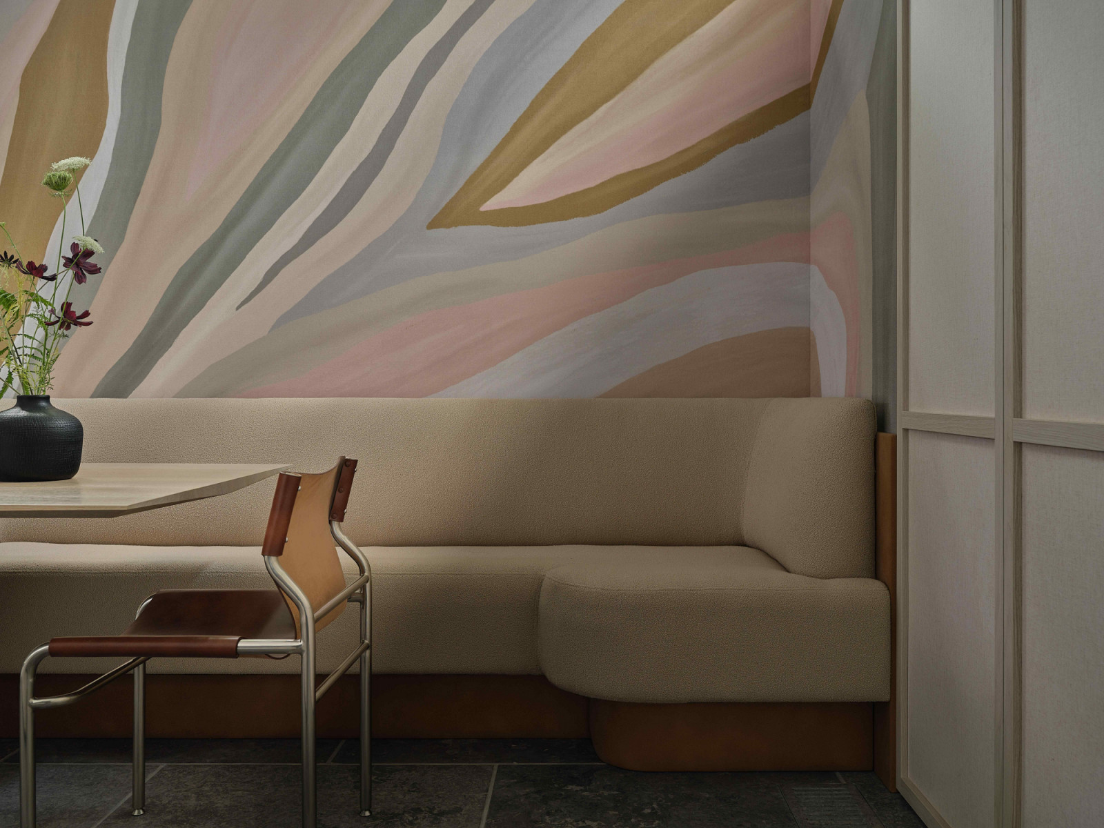 The theme shifts through graphic wall coverings, textured panelled walls and layered finishes