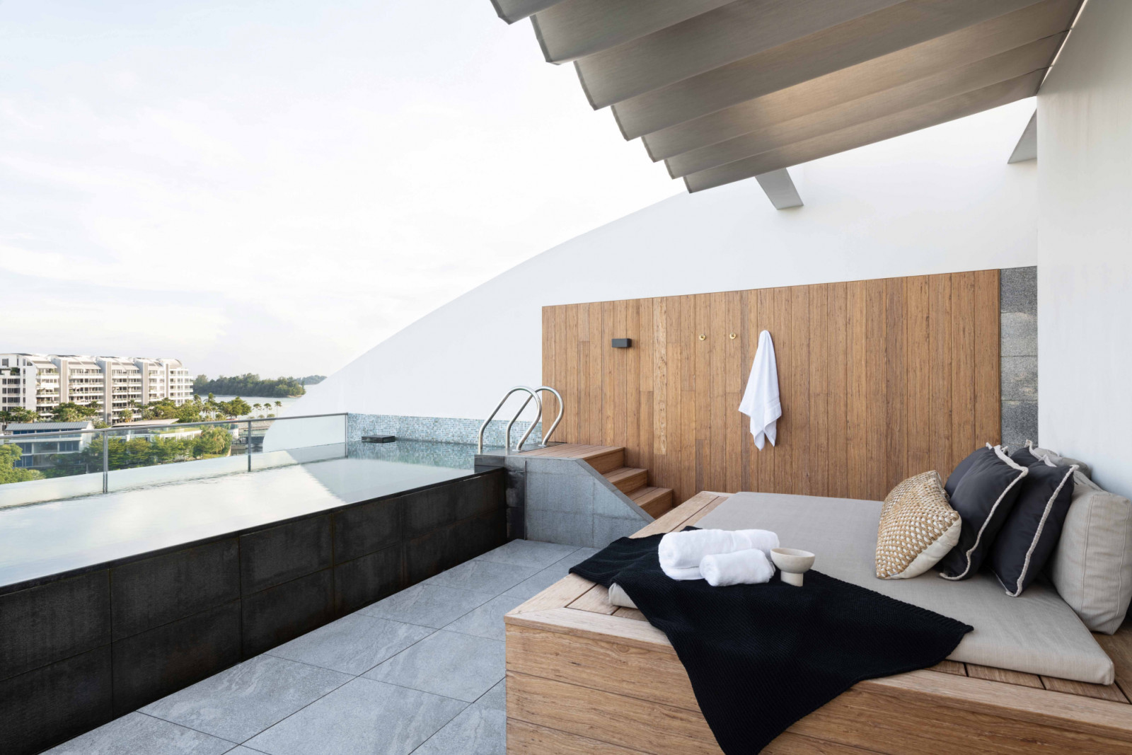 The lap pool deck is accented by natural wood