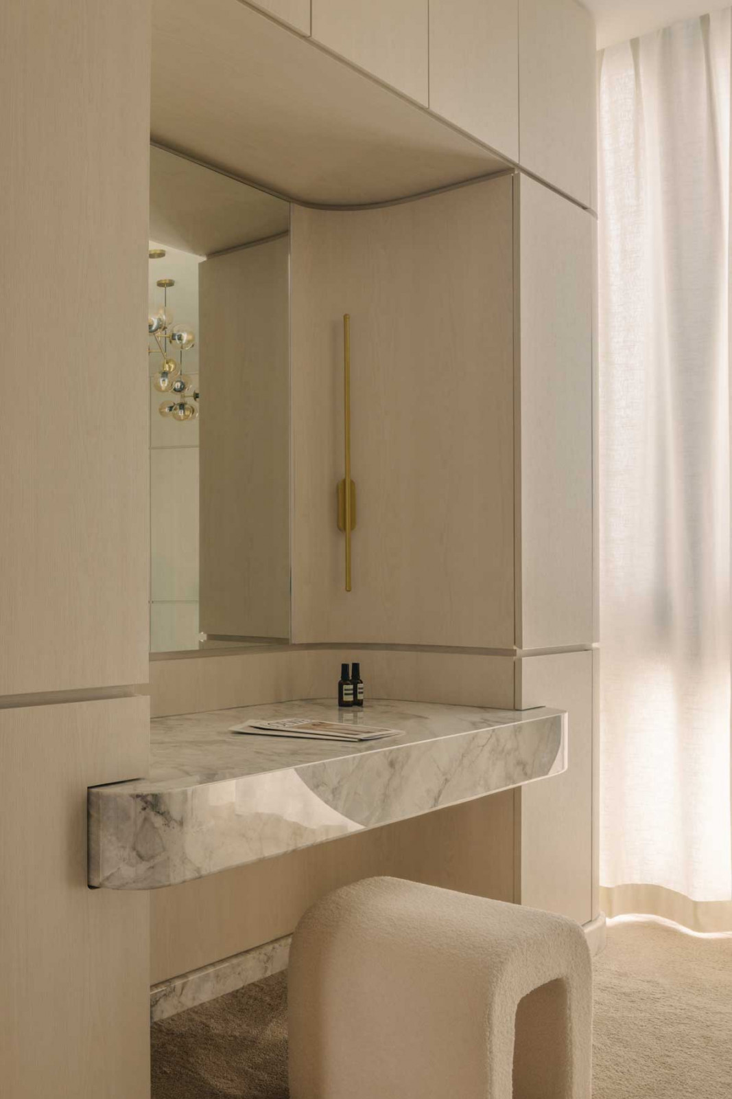 Soft curves are echoed in the vanity area, creating cohesion