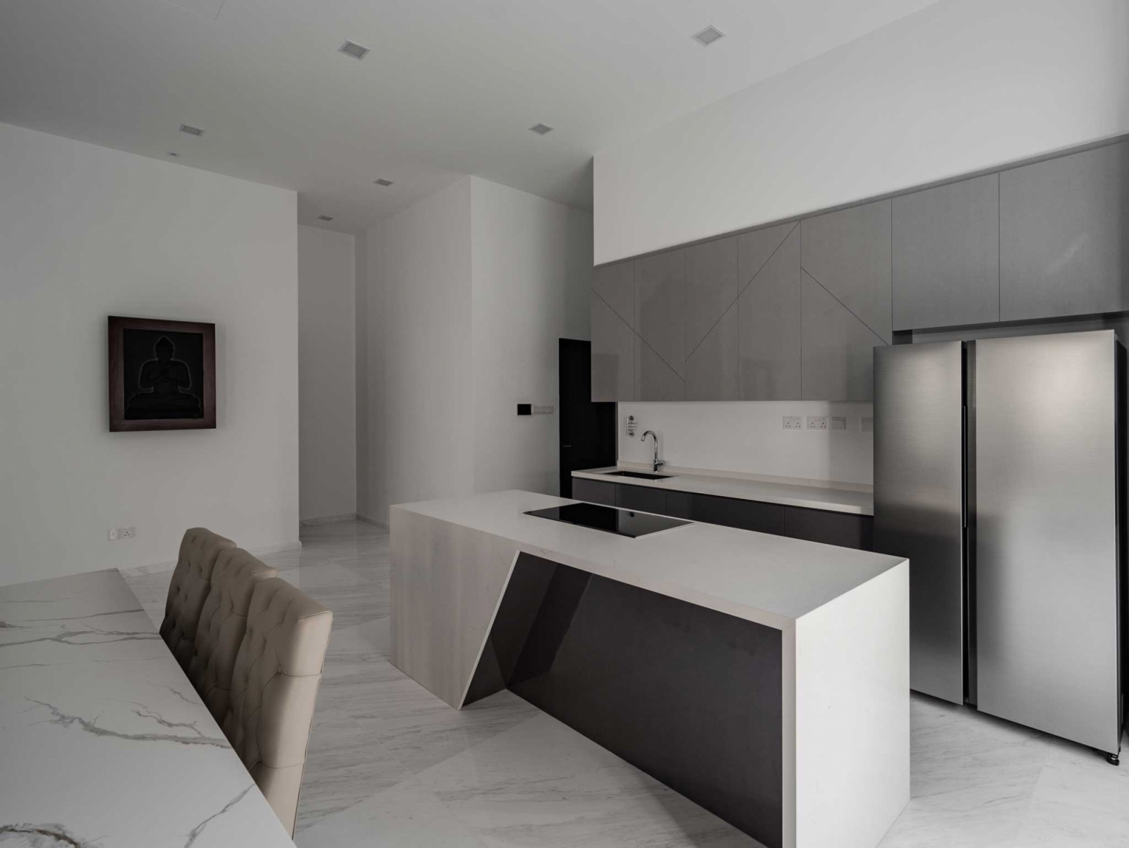 The angular form of the kitchen island in this Serangoon home by M.Spaco creates a striking centrepiece in the culinary zone