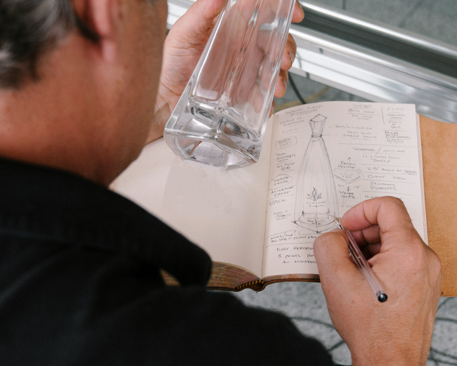 Creative designer Mark Smith sketching the architectural silhouette of the five-sided Cincoro tequila bottle.