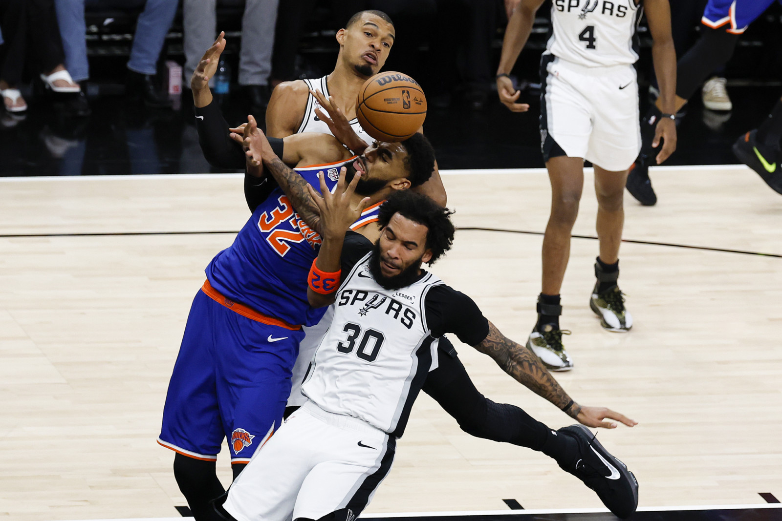 SAN ANTONIO, TEXAS - JUNE 13: Karl-Anthony Towns #32 of the New York Knicks competes for a loose ball with Victor Wembanyama #1 and Julian Champagnie #30 of the San Antonio Spurs during the first quarter in Game Five of the 2026 NBA Finals at Frost Bank Center on June 13, 2026 in San Antonio, Texas. NOTE TO USER: User expressly acknowledges and agrees that, by downloading and or using this photograph, User is consenting to the terms and conditions of the Getty Images License Agreement. (Photo by Ronald Cort