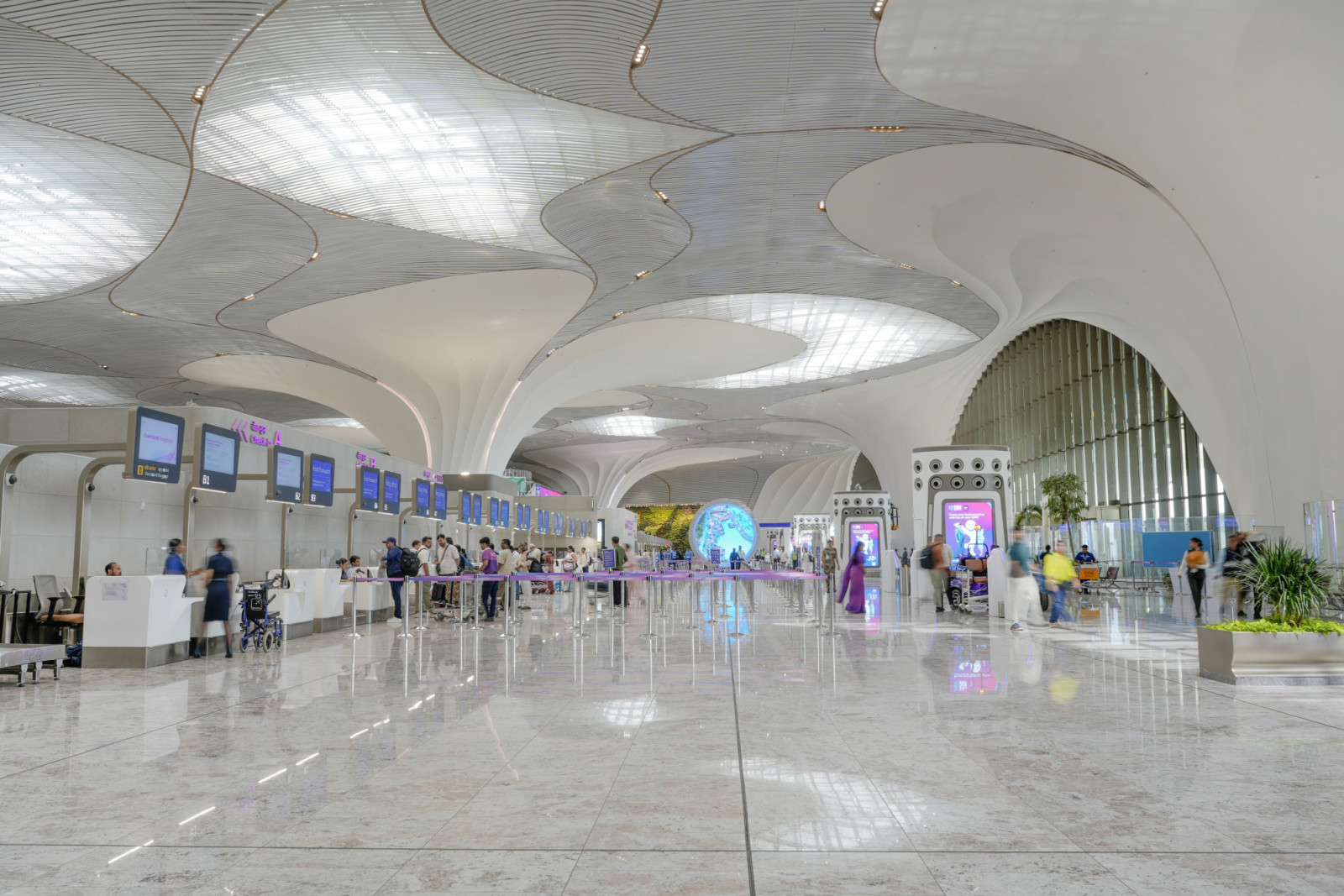 Inside Terminal 1, lotus-inspired columns rise into an overarching ceiling, their petalled forms unfurling overhead like the sacred flower that gave the terminal its design language