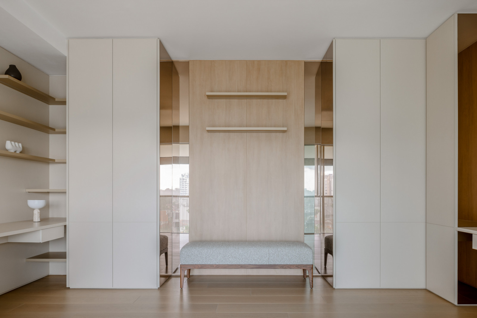 Mirror-clad surfaces catch fragments of reflection and shadow, lending depth to the space