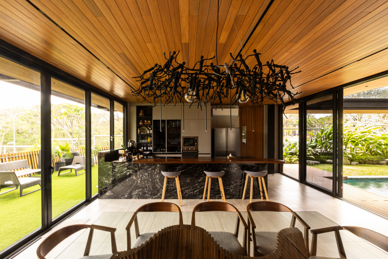 The dining room and kitchen of the Halcyon House in Alabang, Manila by Barchan + Architecture