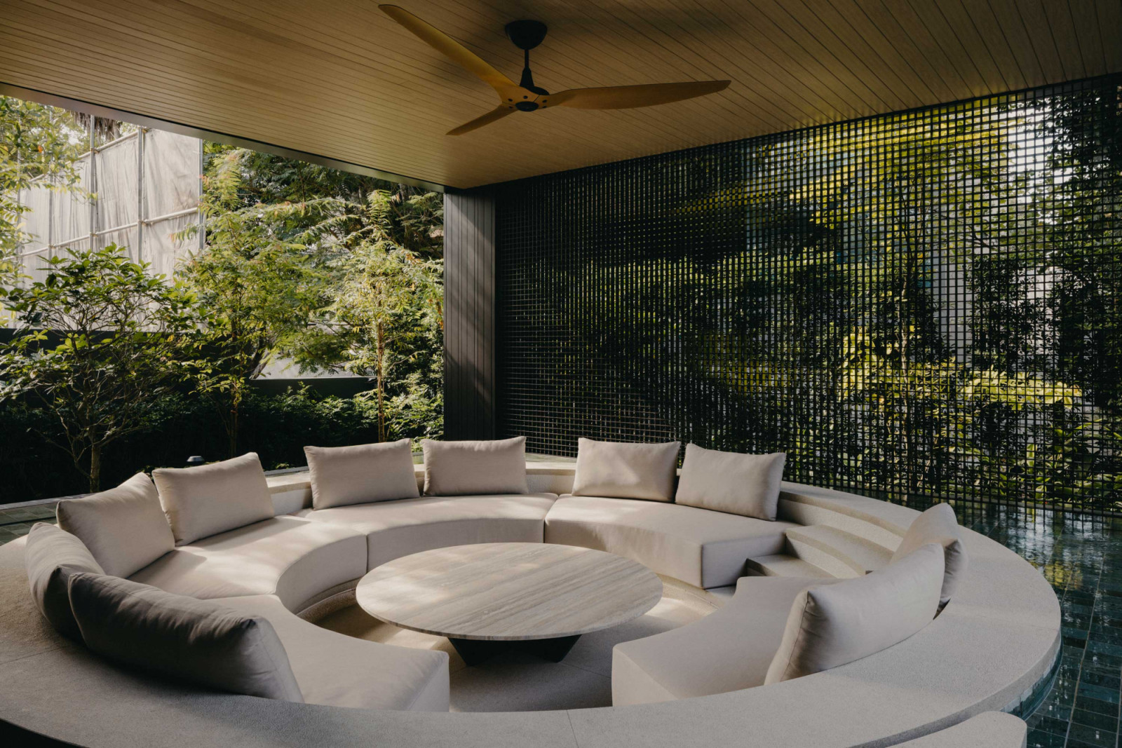 This sunken pavilion lounge set within the pool edge by ArMo Design is framed by Classic's permeable screens that provide shade and privacy