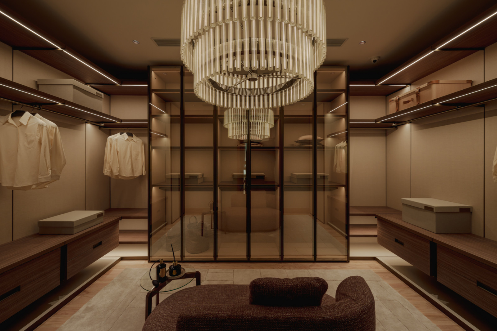 The walk-in wardrobe, fitted with Molteni&C cabinetry and anchored by a statement chandelier