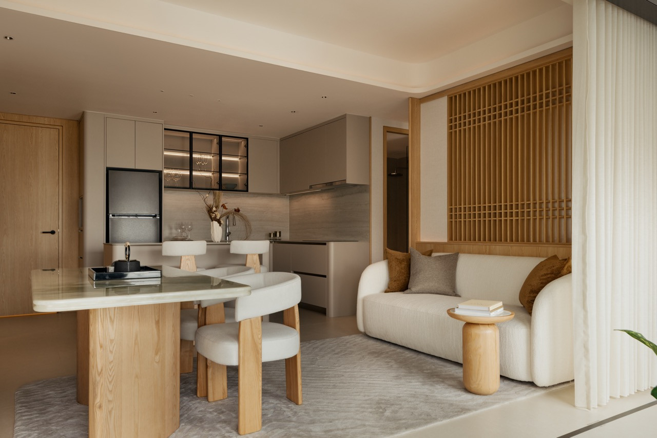 The open-plan living and kitchen of the Type L unit, with a kitchen island in onyx marble and natural oak, reads as a piece of furniture rather than a fixture