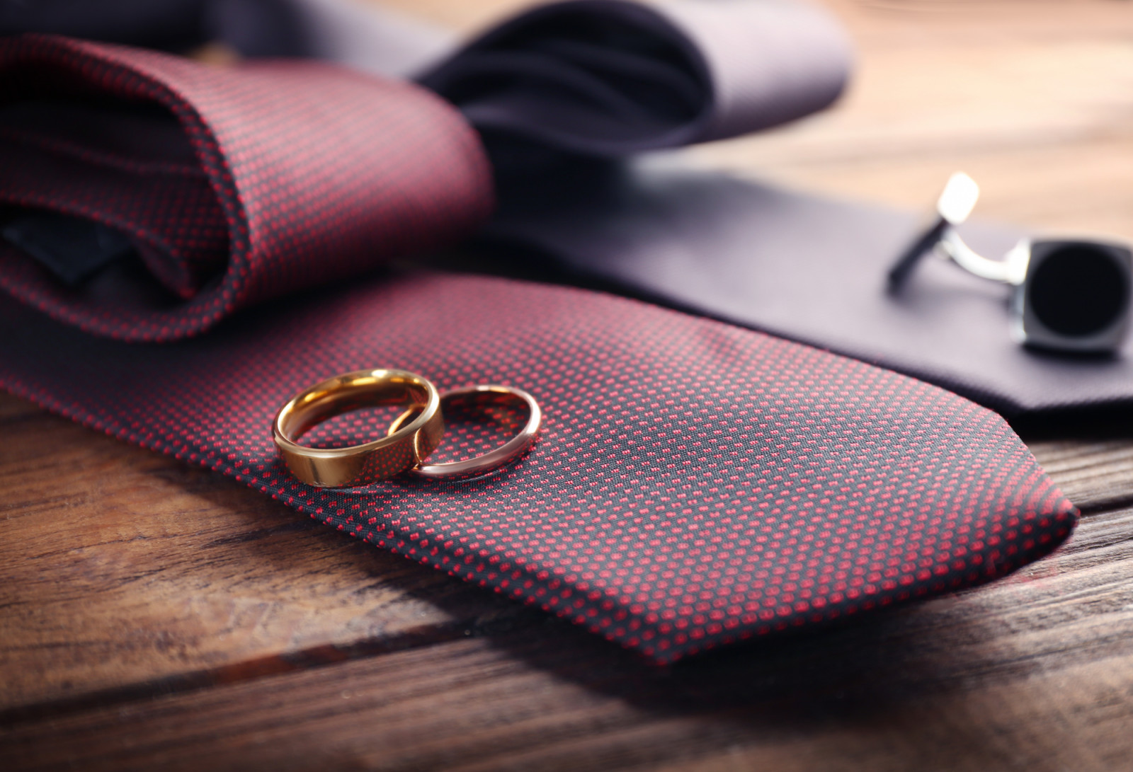 Wedding rings and cuff-links on ties, closeup