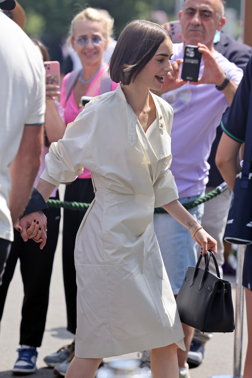 LONDON, ENGLAND - JULY 13: Lily Collins arrives at day fourteen of the Wimbledon Tennis Championships at the All England Lawn Tennis and Croquet Club on July 13, 2025 in London, England. (Photo by Neil Mockford/GC Images)