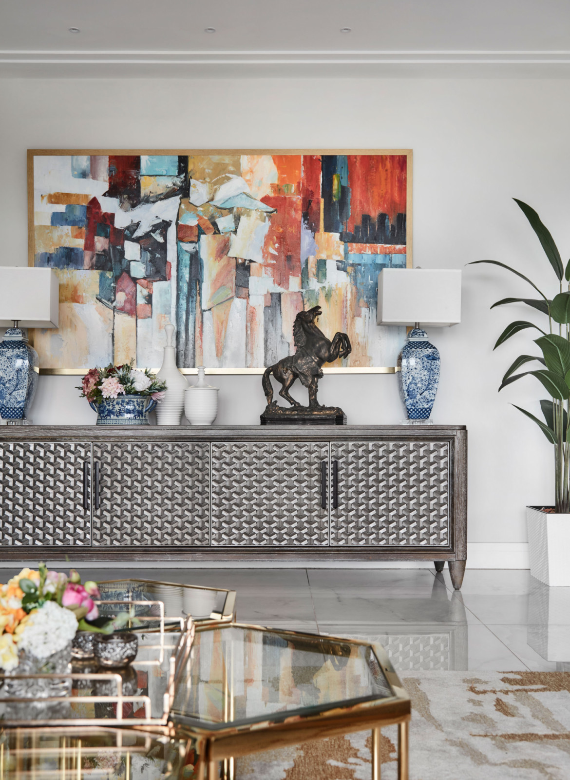 This Pepys Hill apartment features a colourful, layered mix of textures, curved furniture and mixed metals to soften its long linear plan
