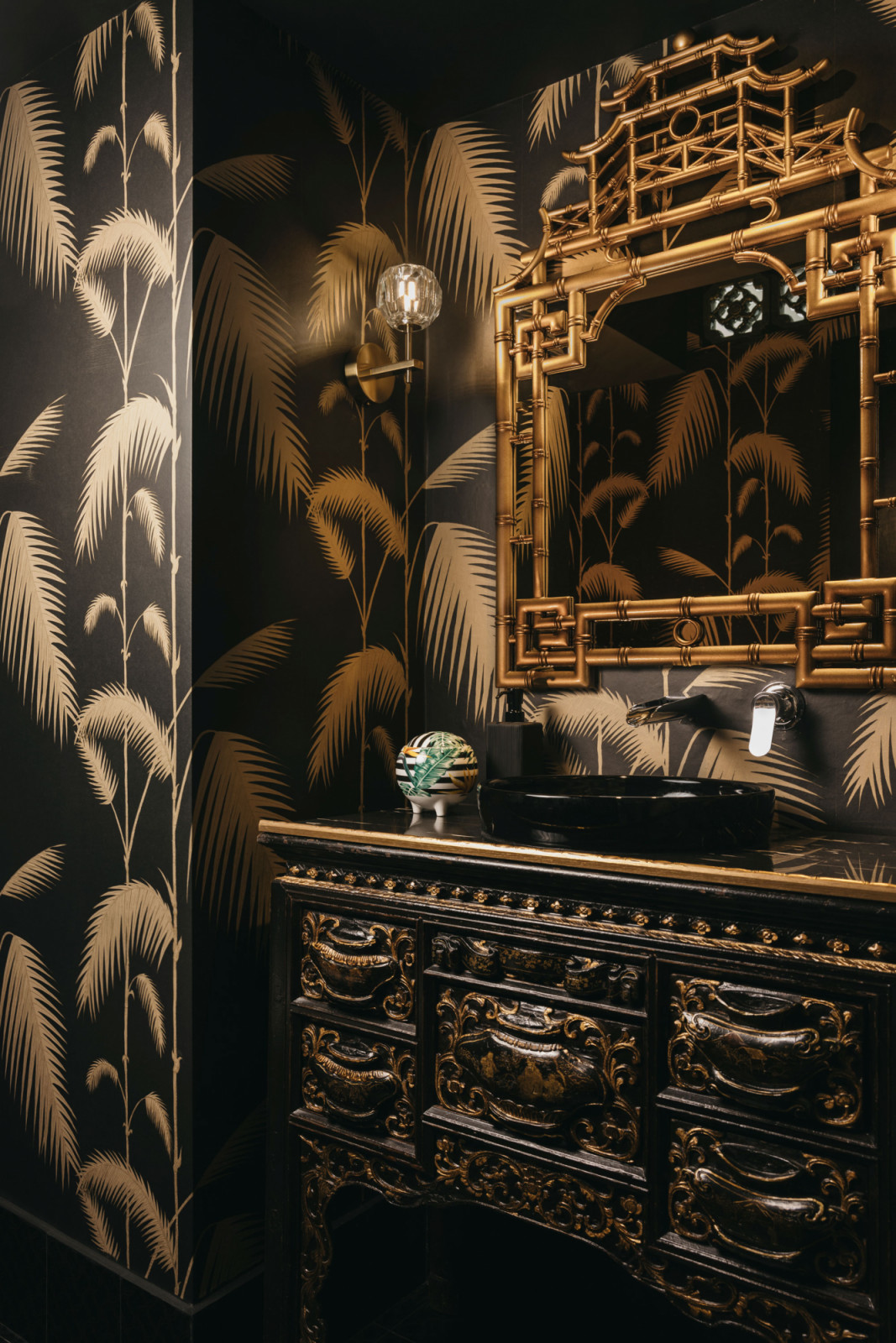 Within the powder room, antique pieces were used to create the vanity