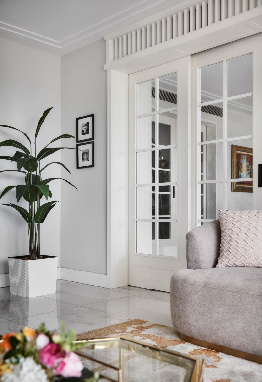 Cased openings, sliding French doors and mirror-lined transoms were introduced throughout the home to visually open up the space