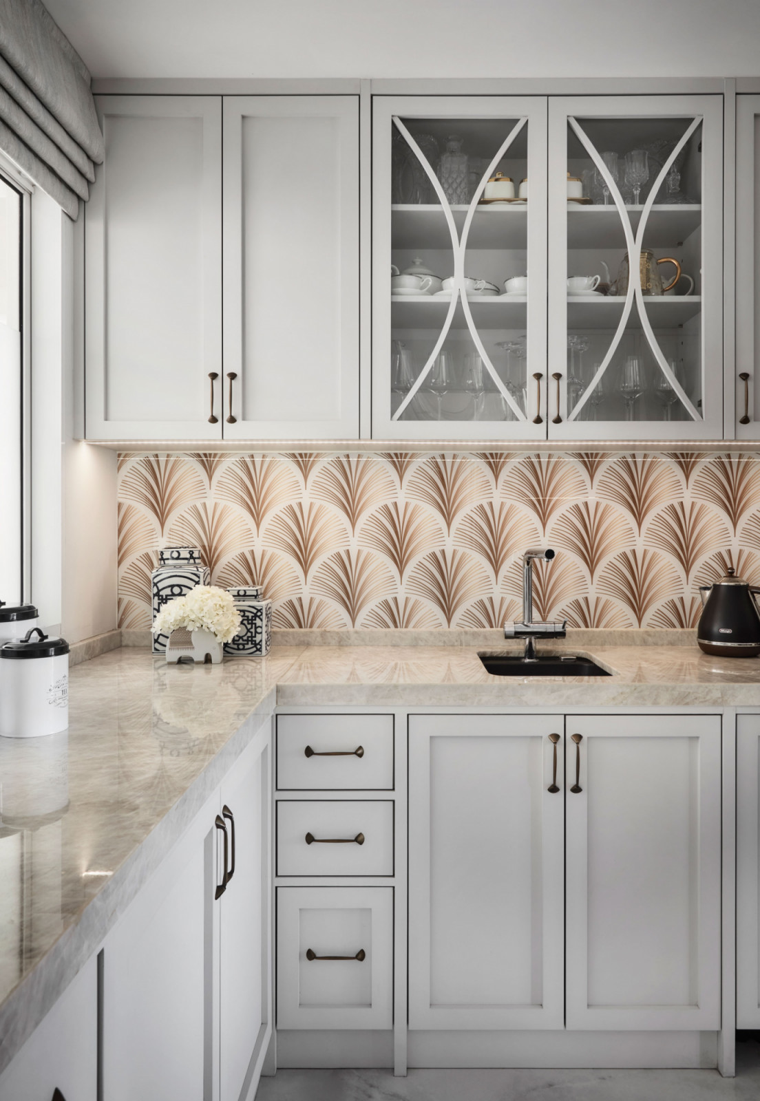 The Art Deco backsplash complements the countertops by Cosentino