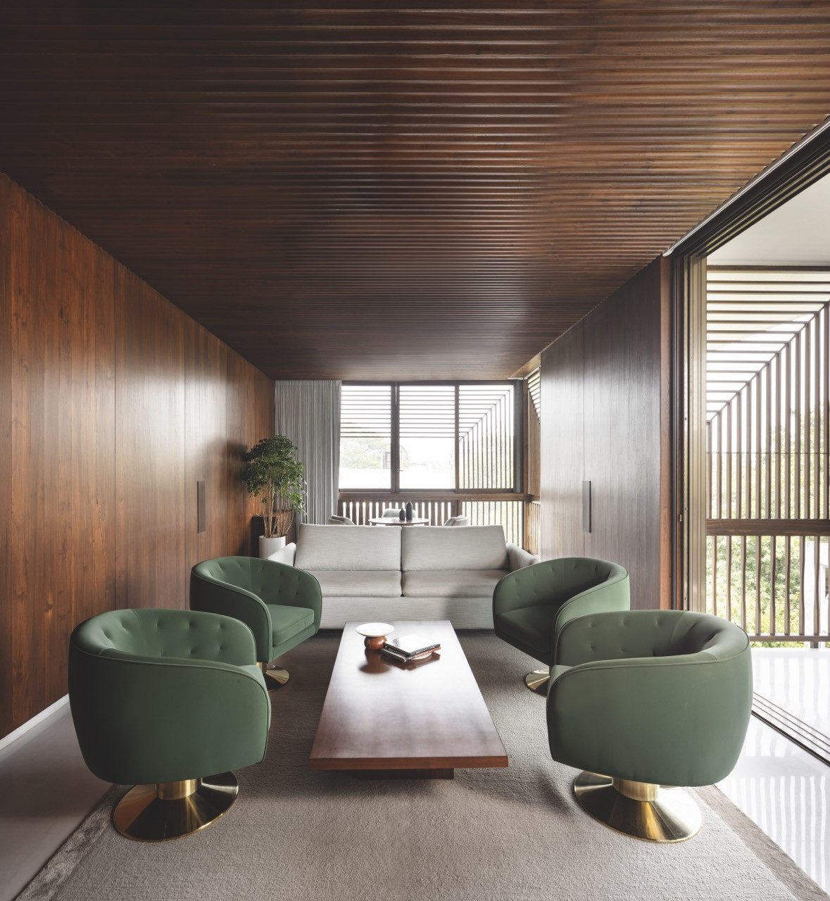 Soft green armchairs add a touch of colour to the mainly neutral palette
