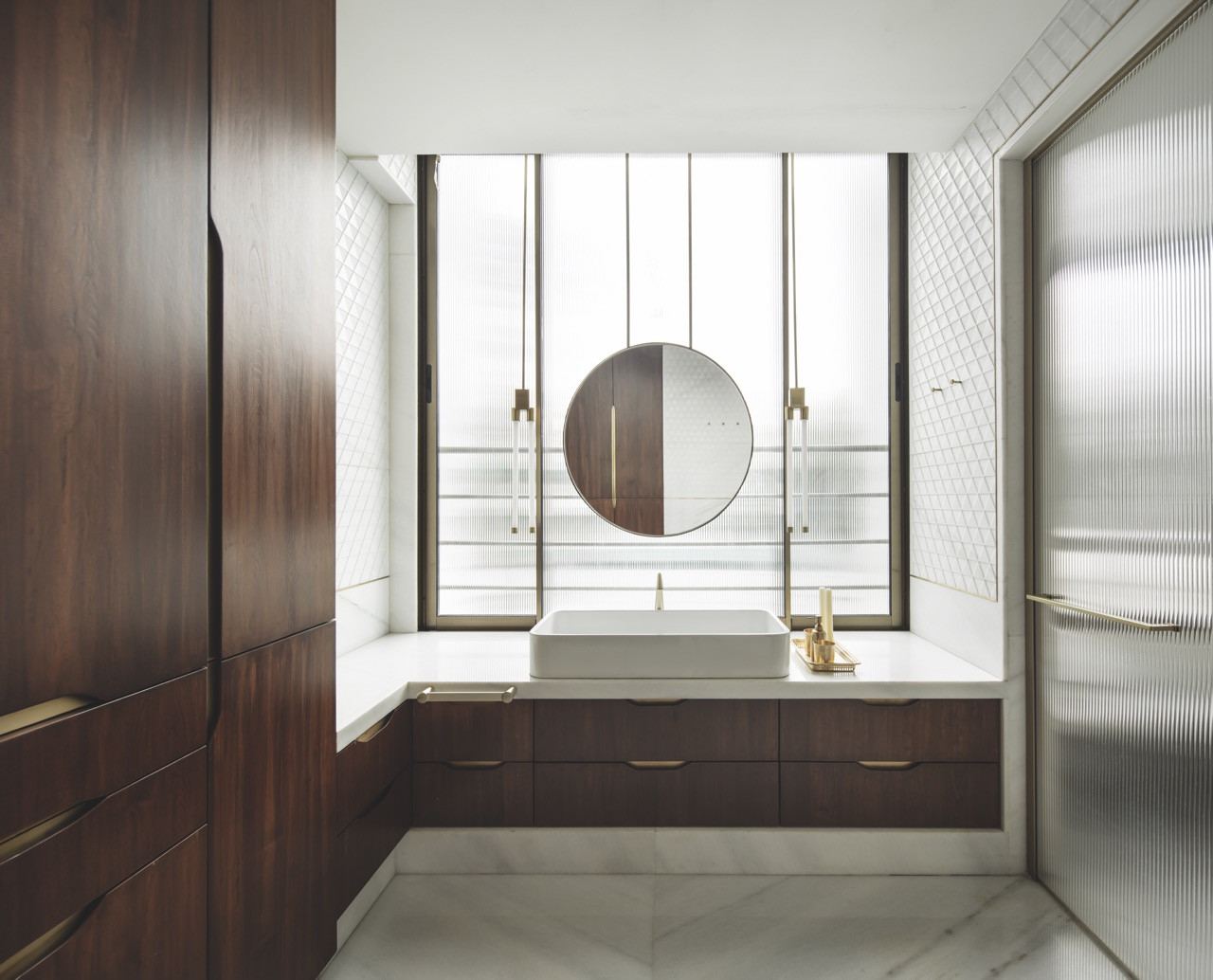 The master bathroom with teak cabinetry, marble surfaces and a window screened by the exterior lattice