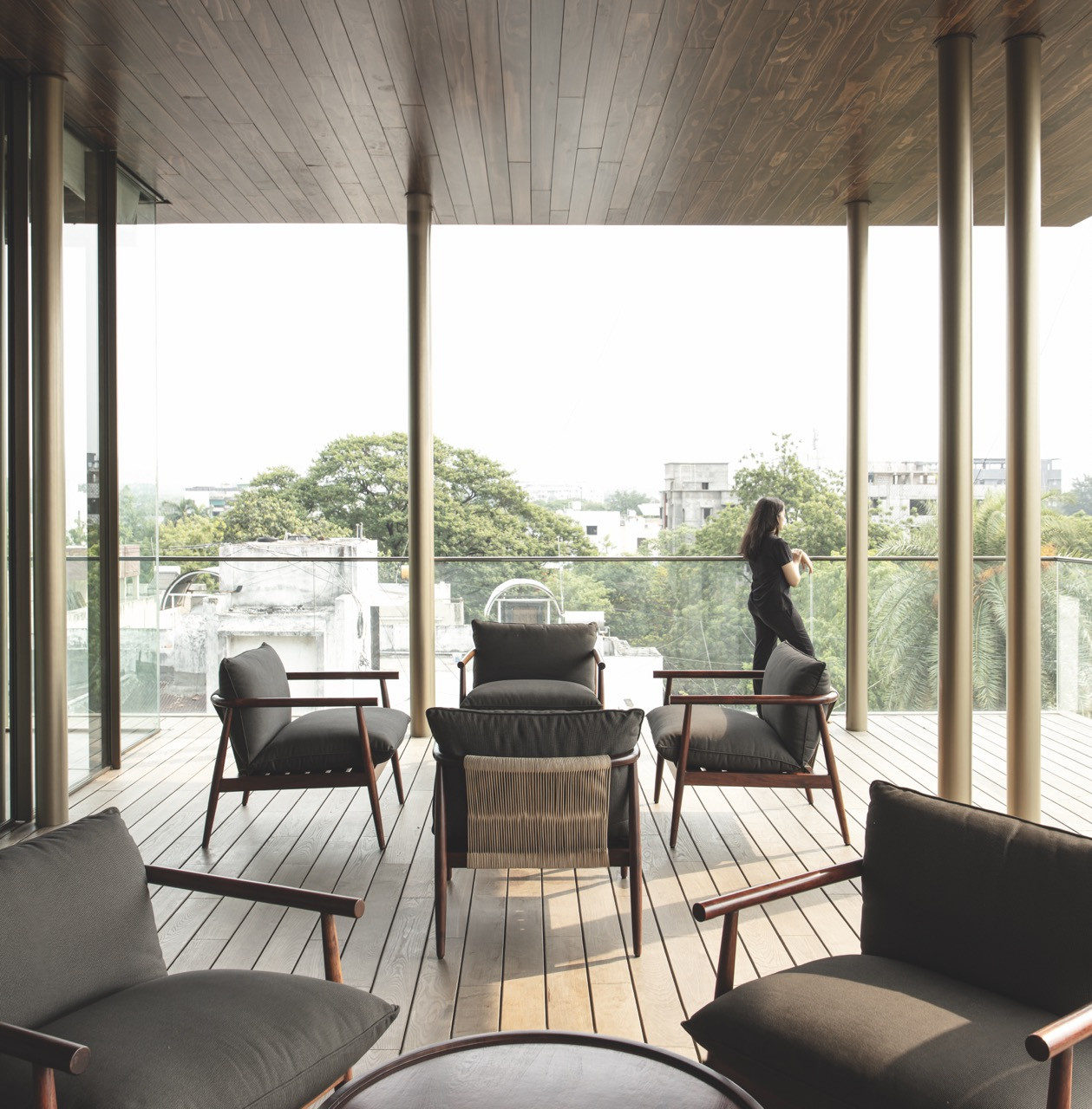 An eight-foot-deep balcony furnished as an outdoor living area, with city views beyond