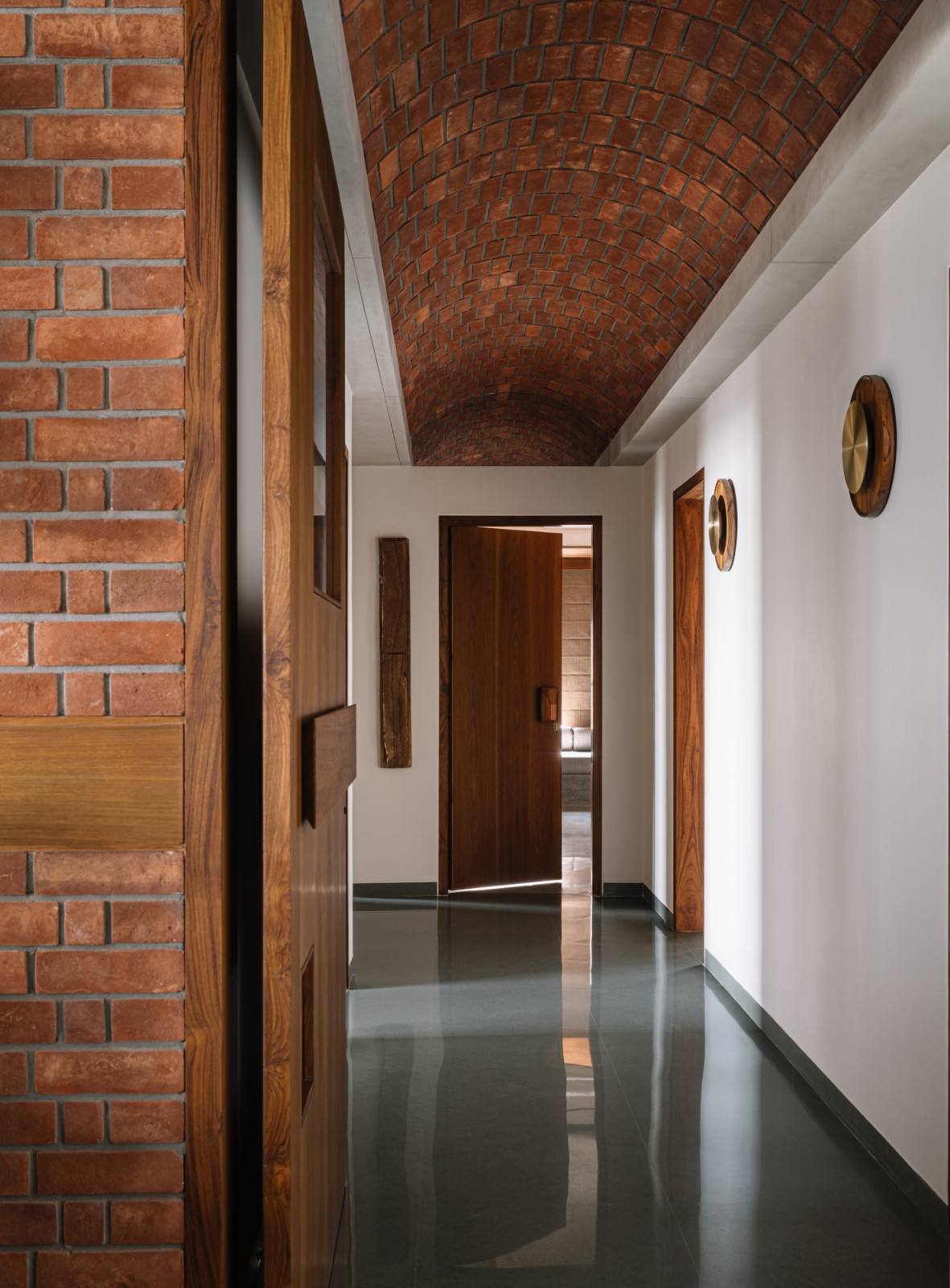 The corridor in a Corbusian-inspired family apartment in Ahmedabad, India, designed by Studio Saransh