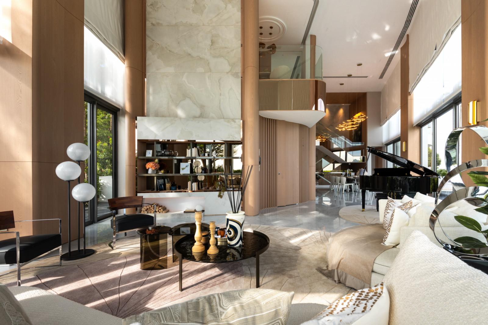ARTG Design Group's Architology Interiors transforms the double-volume living space of Ho Bee Land's Seascape duplex into an airy, light-filled tableau anchored by a soaring marble feature wall