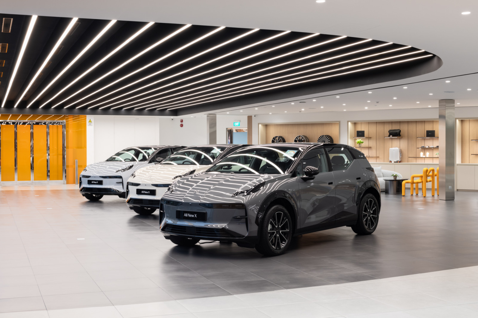 The main showroom floor of the Zeekr Centre Singapore, designed by  Aarticle, balances open display space with a lifestyle retail zone, reflecting the studio's approach to commercial design as an exercise in brand storytelling
