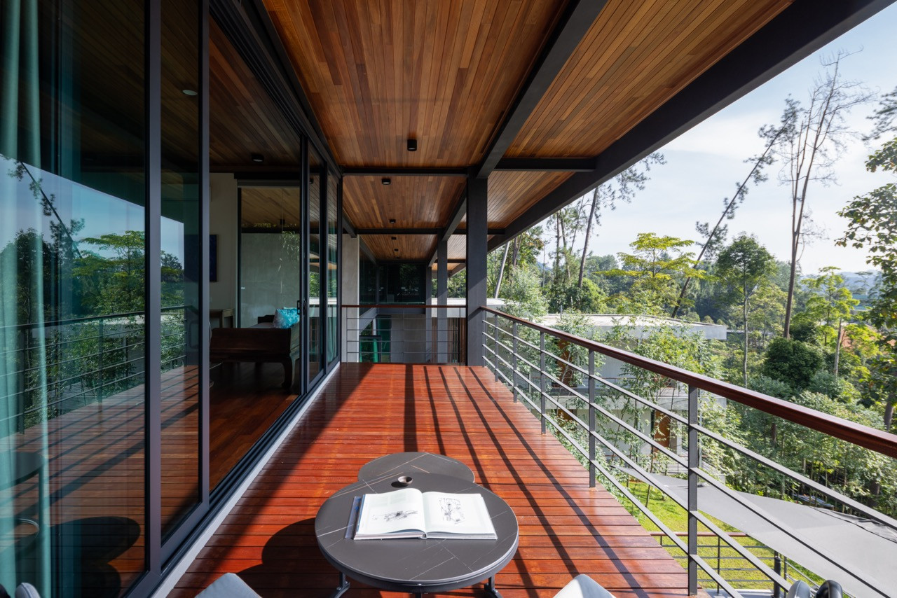 A covered upper terrace with nyatoh timber ceiling and merbau decking looks out over the forest canopy