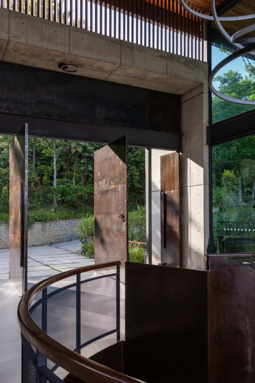 The three pivoted steel doors of the entrance lobby, opened to dissolve the boundary between interior and landscape