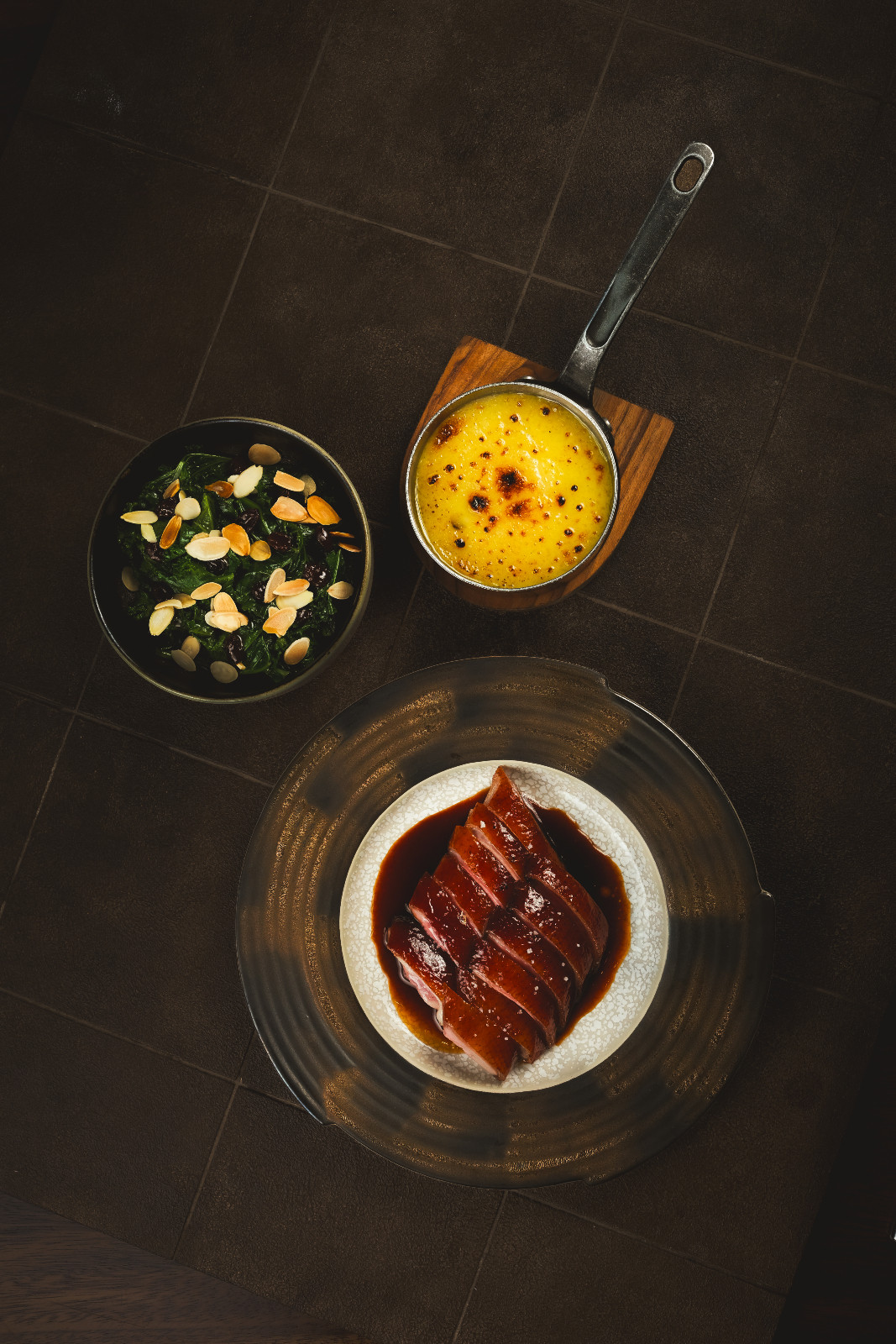 Dry-aged duck with crispy skin, potted leg confit, sautéed kale