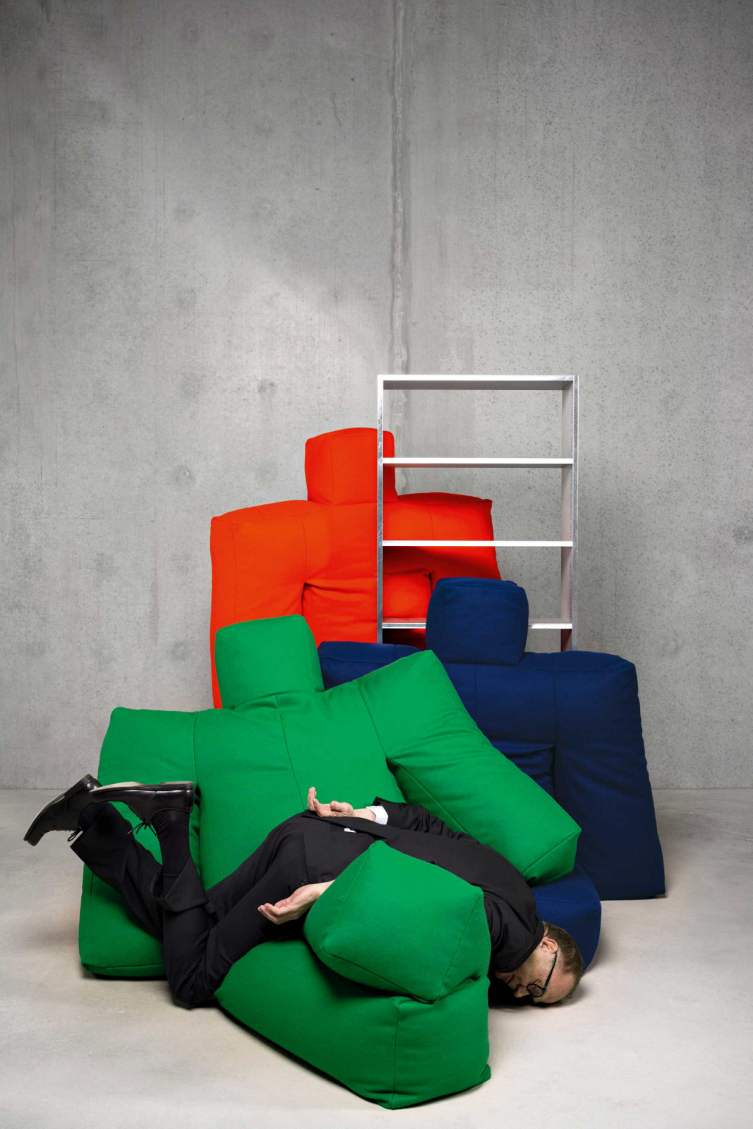 Designer Heimo Zobernig playfully posing with his Dammi i Colori series for Moroso